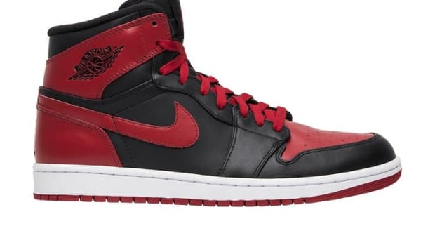 Side view of red and black Air Jordan sneakers.